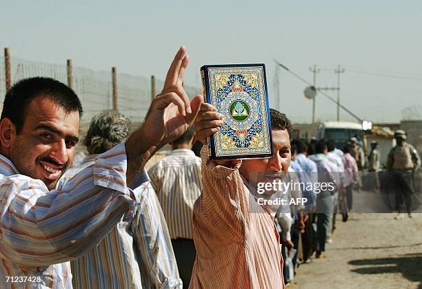 Iraqi prisoners wave as they wait to be released 19 June 2006 Abu Ghraib prison west of Baghdad. Iraq released 500 detainees, the fourth batch of...