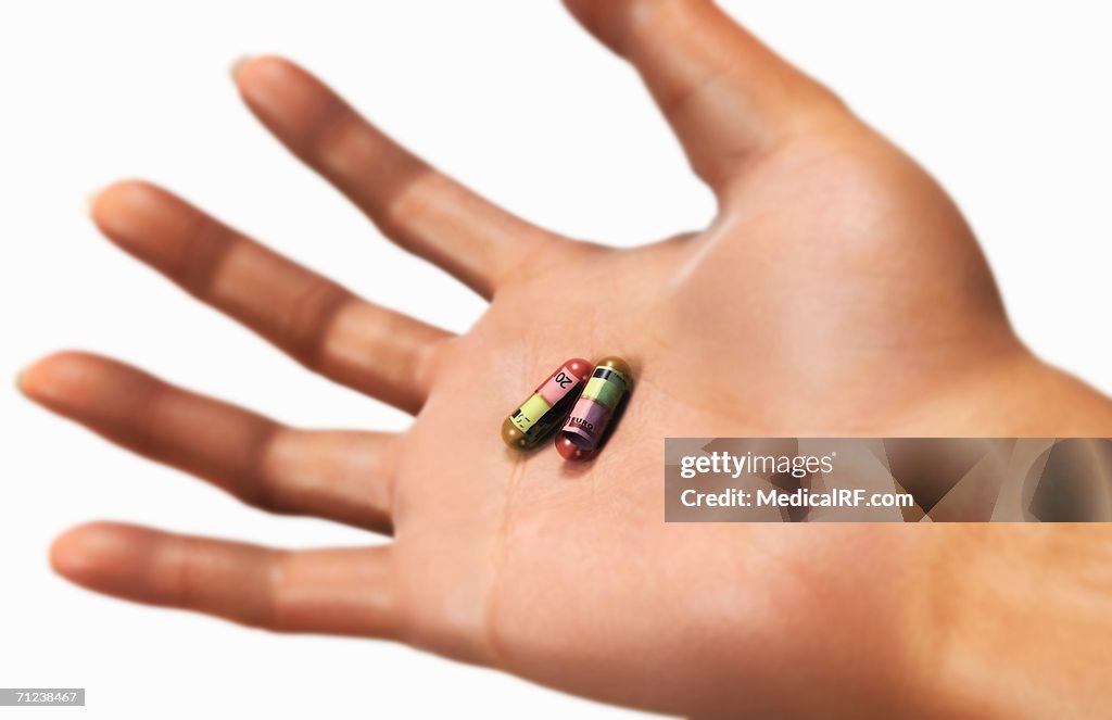 Capsules in open palm.