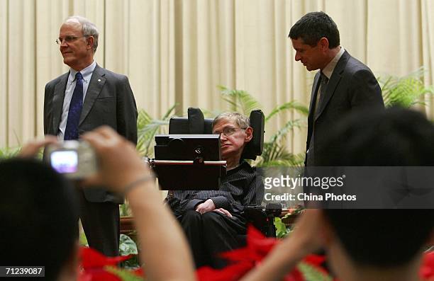 British scientist Stephen Hawking attends a photo call with U.S. Physicists David Gross and Andrew Strominger at the opening ceremony of "Strings...