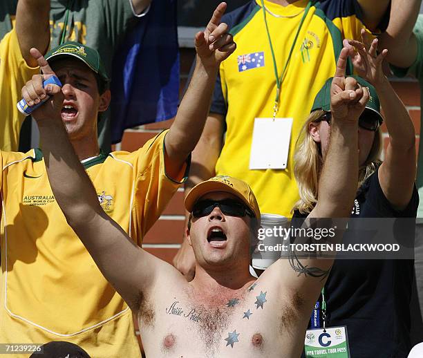An Australian fan, with The Southern Cross tattooed on his chest, cheers on the Socceroos during their training session in Ohringen, 19 June 2006....