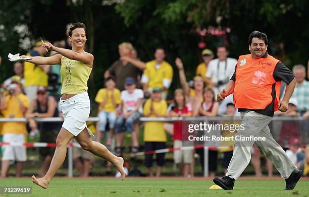 Young woman runs onto the pitch to get player autographs during the Australian training session at the Otto-Meister Stadium June 19, 2006 in...