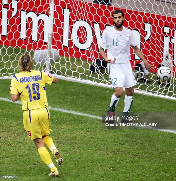 Ukrainian midfielder Maksim Kalinichenko jubilates after scoring as Saudi defender Abdulaziz Khathran looks dejected during the World Cup 2006 group...