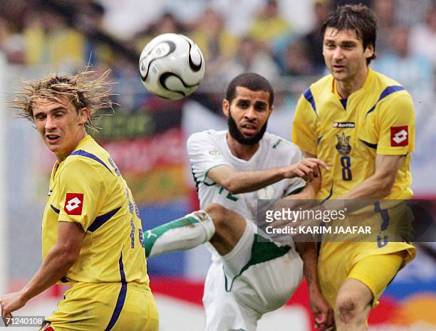 Saudi defender Abdulaziz Khathran is challanged by Ukrainian midfielder Maksim Kalinichenko and midfielder Oleg Shelayev during the World Cup 2006...