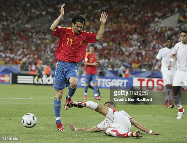 Luis Garcia of Spain is tackled by Anis Ayari of Tunisia during the FIFA World Cup Germany 2006 Group H match between Spain and Tunisia at the...