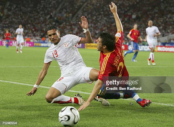 David Villa of Spain is brought down by Anis Ayari of Tunisia during the FIFA World Cup Germany 2006 Group H match between Spain and Tunisia at the...