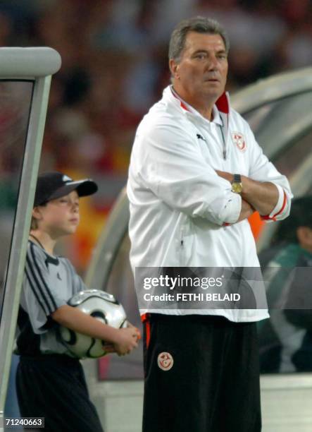 French head coach of the Tunisian team Roger Lemerre watches the action during the opening round Group H World Cup football match between Spain and...