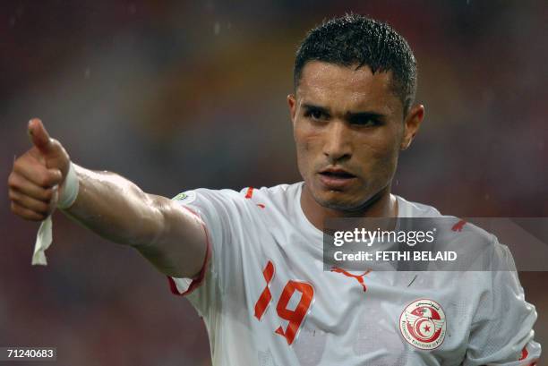 Tunisian defender Anis Ayari gives a thumbs up in the first half of the opening round Group H World Cup football match between Spain and Tunisia at...