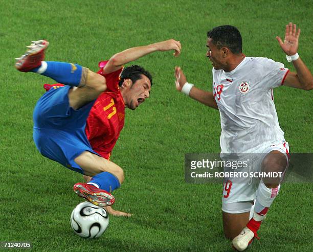 Spanish forward Luis Garcia falls down as Tunisian defender Anis Ayari gestures following a challenge during the opening round Group H World Cup...