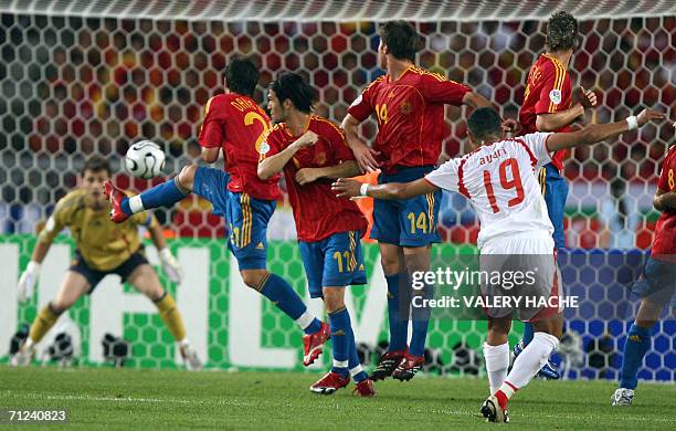 The Spanish team defends off a free kick by Tunisian defender Anis Ayari during the opening round Group H World Cup football match between Spain and...