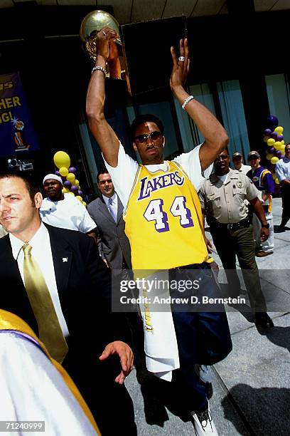 Kobe Bryant of the Los Angeles Lakers proudly displays the NBA Championship trophy during the Lakers' 2001 NBA Championship parade held June 18, 2001...