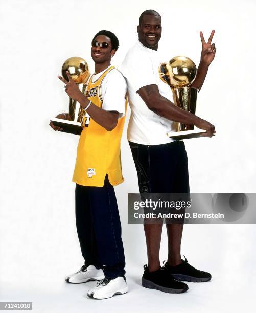 Shaquille O'Neal and Kobe Bryant of the Los Angeles Lakers pose for a photo after the Lakers' 2001 NBA Championship parade held June 18, 2001 in Los...