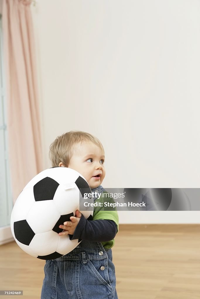 Baby boy holding a football