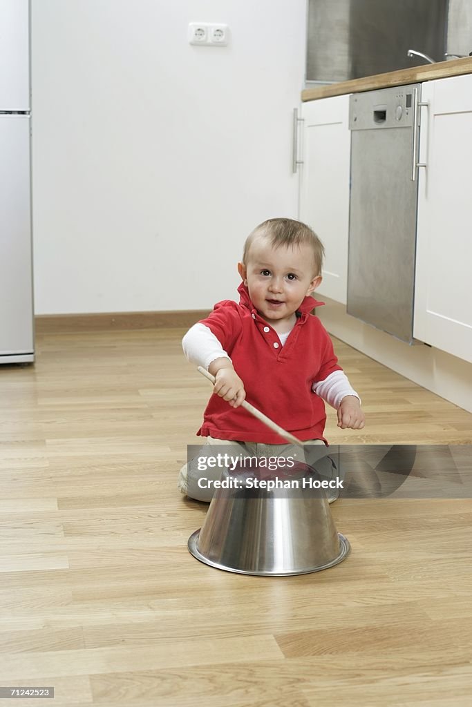 Baby boy drumming on a  dish