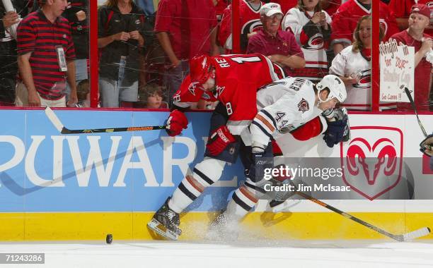 Chris Pronger of the Edmonton Oilers and Mark Recchi of the Carolina Hurricanes clash during game seven of the 2006 NHL Stanley Cup Finals on June...