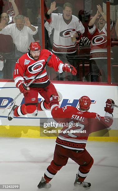 Justin Williams of the Carolina Hurricanes and teammate Eric Staal celebrate after Williams scored the game winning shot over the Edmonton Oilersgame...