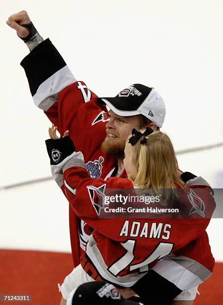 Kevyn Adams of the Carolina Hurricanes celebrates with his daughter after defeating the Edmonton Oilers in game seven of the 2006 NHL Stanley Cup...
