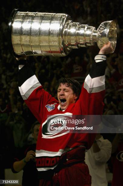 Rod Brind'Amour of the Carolina Hurricanes celebrates with the Stanley Cup after defeating the Edmonton Oilers in game seven of the 2006 NHL Stanley...