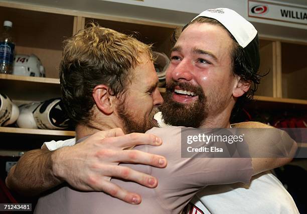 Kevyn Adams and Justin Williams of the Carolina Hurricanes celebrate in the lockerroom after defeating the Edmonton Oilers in game seven of the 2006...