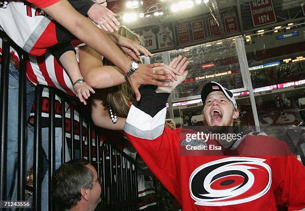 Eric Staal of the Carolina Hurricanes celebrates with fans after defeating the Edmonton Oilers in game seven of the 2006 NHL Stanley Cup Finals on...