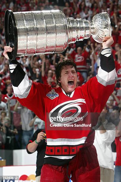 Rod Brind'Amour of the Carolina Hurricanes celebrates with the Stanley Cup after defeating the Edmonton Oilers in game seven of the 2006 NHL Stanley...