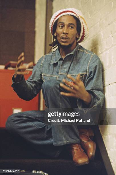 Jamaican reggae singer-songwriter and musician Bob Marley pictured wearing a denim jacket, jeans and a rastacap at the offices of Island Records,...