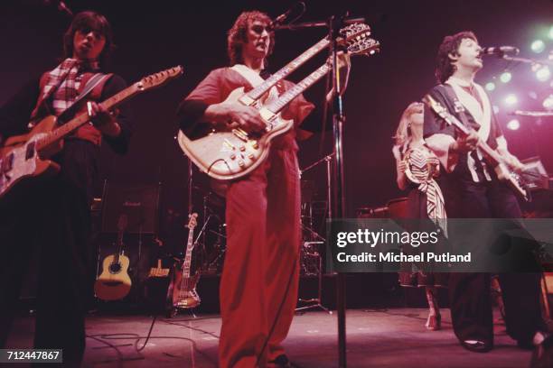 Rock group Wings perform live on stage on their Wings Over the World tour in March 1976. The band are, from left to right: Jimmy McCulloch , Denny...