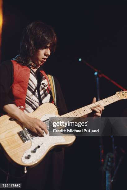 Scottish musician and guitarist Jimmy McCulloch performs live on stage with rock group Wings on their Wings Over the World tour in March 1976.