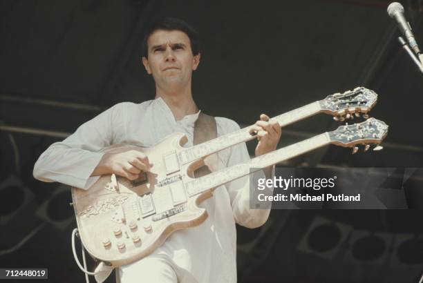 English guitarist and composer John McLaughlin performs live on stage playing a double neck guitar at a festival in the United Kingdom on 7th...