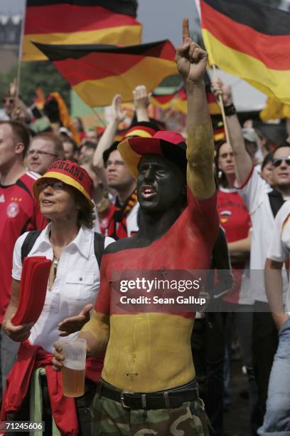 German soccer fans cheer while watching Germany play Ecuador in their Group A match on a giant television screen at an open air viewing area June 20,...