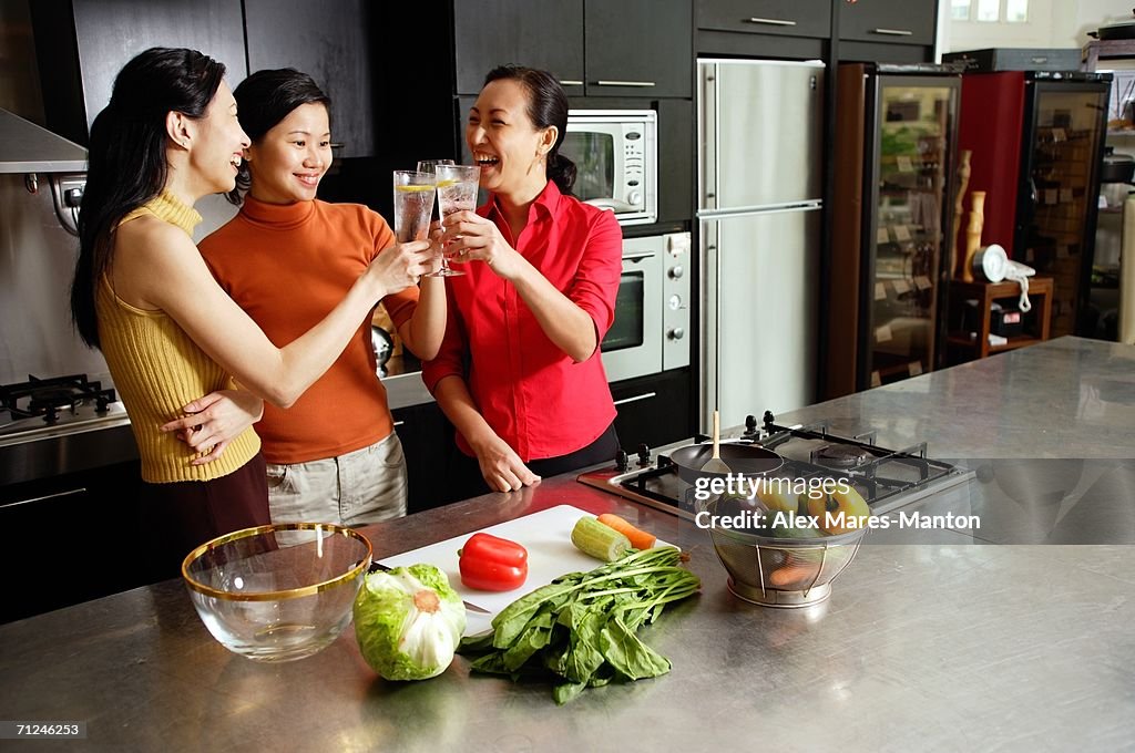 Women in kitchen, toasting