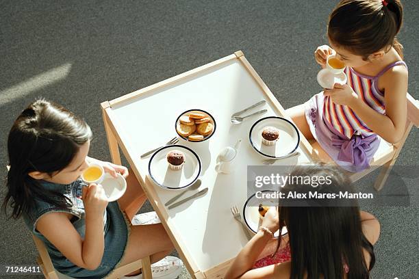 three girls having a tea party - only girls fotografías e imágenes de stock