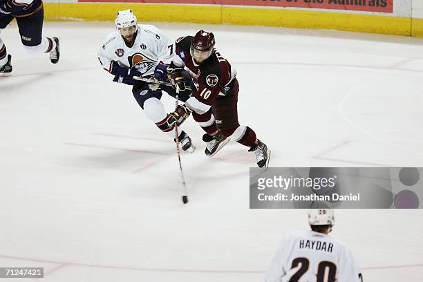 Joey Tenute of the Hershey Bears skates with the puck against Ryan Parent of the Milwaukee Admirals in game six of the Calder Cup Finals on June 15,...
