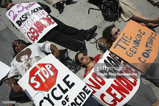 Demonstrators stage a die-in along the north side of the White House during a rally to mark World Refugee Day and to highlight the ongoing violence...