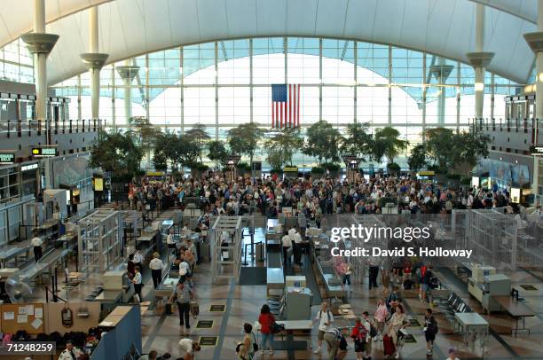 Travelers pass through security screening at the Jeppesen Terminal, named after aviation pioneer Elrey B. Jeppesen as seen at Denver International...