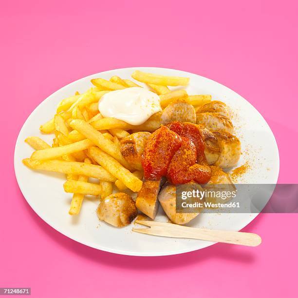 currywurst and french fries with sauce in plate, close-up - currywurst stock pictures, royalty-free photos & images