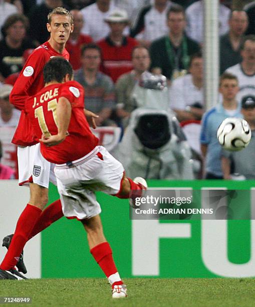 English midfielder Joe Cole shoots and scores next to his teammate forward Peter Crouch during the opening round Group B World Cup football match...