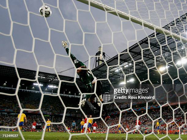 Goalkeeper Andreas Isaksson of Sweden dives but fails to save Joe Cole's shot during the FIFA World Cup Germany 2006 Group B match between Sweden and...