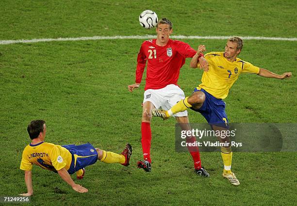Peter Crouch of England battles with Tobias Linderoth of Sweden and Teddy Lucic of Sweden during the FIFA World Cup Germany 2006 Group B match...