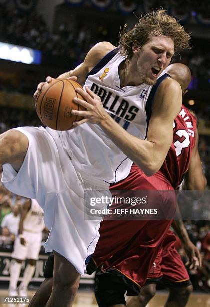 Dallas, UNITED STATES: Dirk Nowitzki of the Dallas Mavericks hauls in a rebound against Alonzo Mourning of the Miami Heat during Game Six of the NBA...