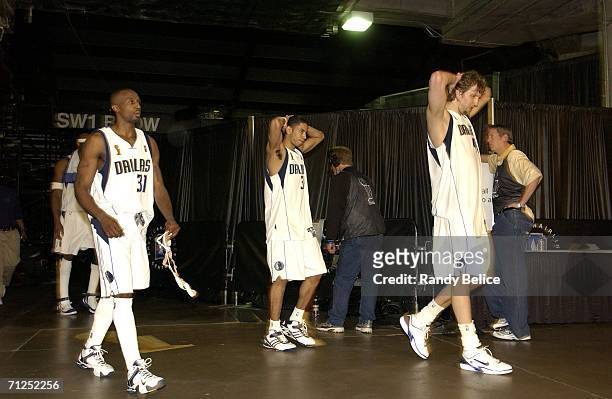 Jason Terry, Devin Harris and Dirk Nowitzki of the Dallas Mavericks leave the court after losing Game Six of the 2006 NBA Finals against the Miami...