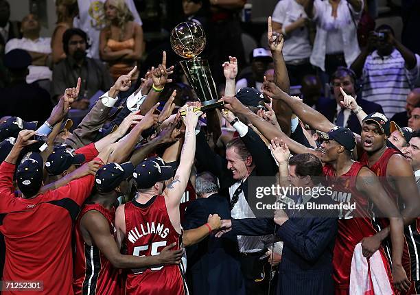 The Miami Heat hold the Larry O'Brien Trophy after the Heat won the 2006 NBA Finals after defeating the Dallas Mavericks 95-92 on June 20, 2006 at...