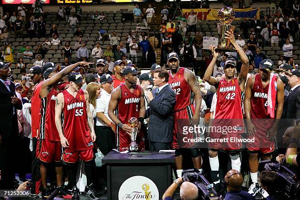 Dwyane Wade of the Miami Heat receives the Finals MVP trophy from ABC's Dan Patrick after the Heat beat the Dallas Mavericks 95-92 during Game Six of...
