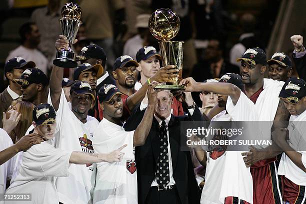 Dallas, UNITED STATES: Miami Heat head coah Pat Riley celebrates with team members after winning the NBA Finals 95-92 in Game Six against the Dallas...