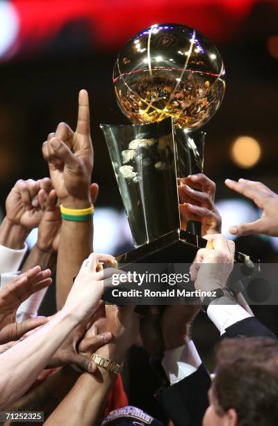 The Miami Heat hold up the Larry O'Brien trophy after they defeated the Dallas Mavericks in game six of the 2006 NBA Finals on June 20, 2006 at...
