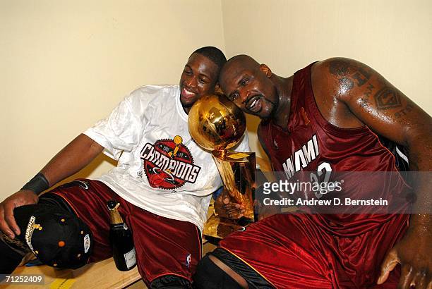 Dwyane Wade and Shaquille O'Neal of the Miami Heat celebrate with the Larry O'Brien Championship trophy after their Game Six victory of the 2006 NBA...