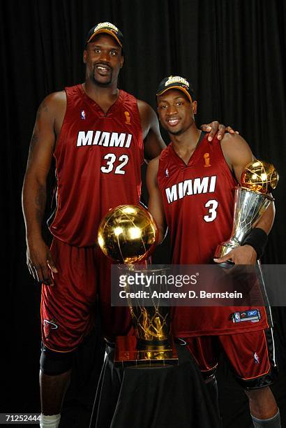 Shaquille O'Neal and Dwyane Wade of the Miami Heat pose for a portrait with the Larry O'Brien Championship trophy and MVP trophy after their Game Six...