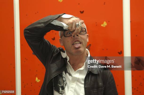 Damien Hirst gestures as he attends his 'A Thousand Years and Triptychs' private view at the Gagosian Gallery on June 20, 2006 in London, England.