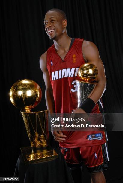 Dwyane Wade of the Miami Heat poses for a portrait with the Larry O'Brien Championship trophy and the MVP trophy after their Game Six victory of the...