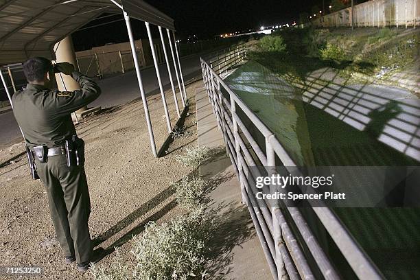 Border Patrol agent keeps watch along the U.S. Mexican border June 20, 2006 in Douglas, Arizona. Most of the residents of the home,...