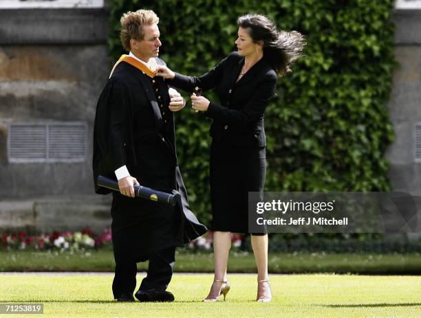 Michael Douglas and his wife Catherine Zeta Jones prepare to be photographed after receiving his honorary degree from St Andrews University June 21,...